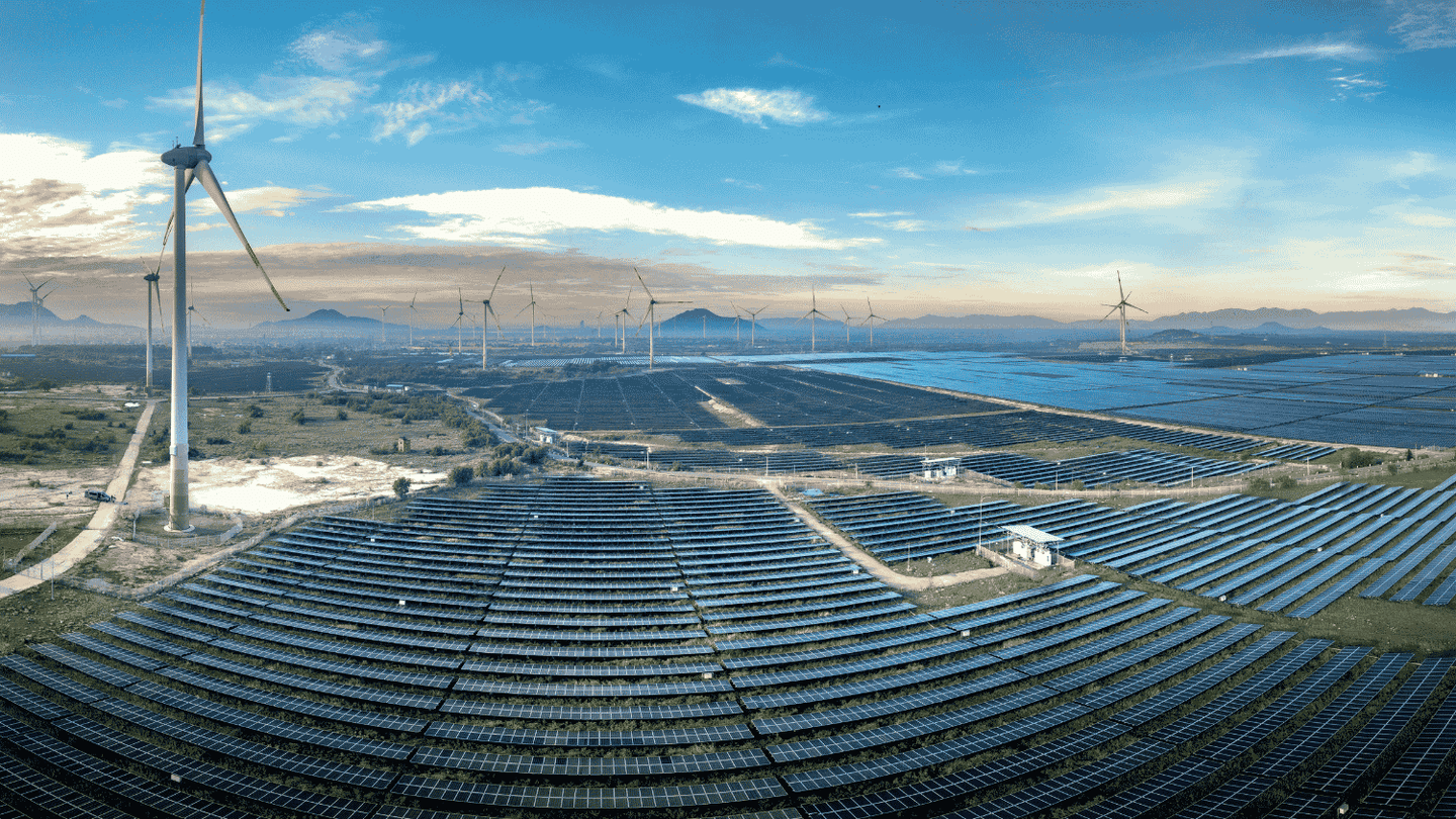 Solar panels and wind turbines at a renewable energy project.
