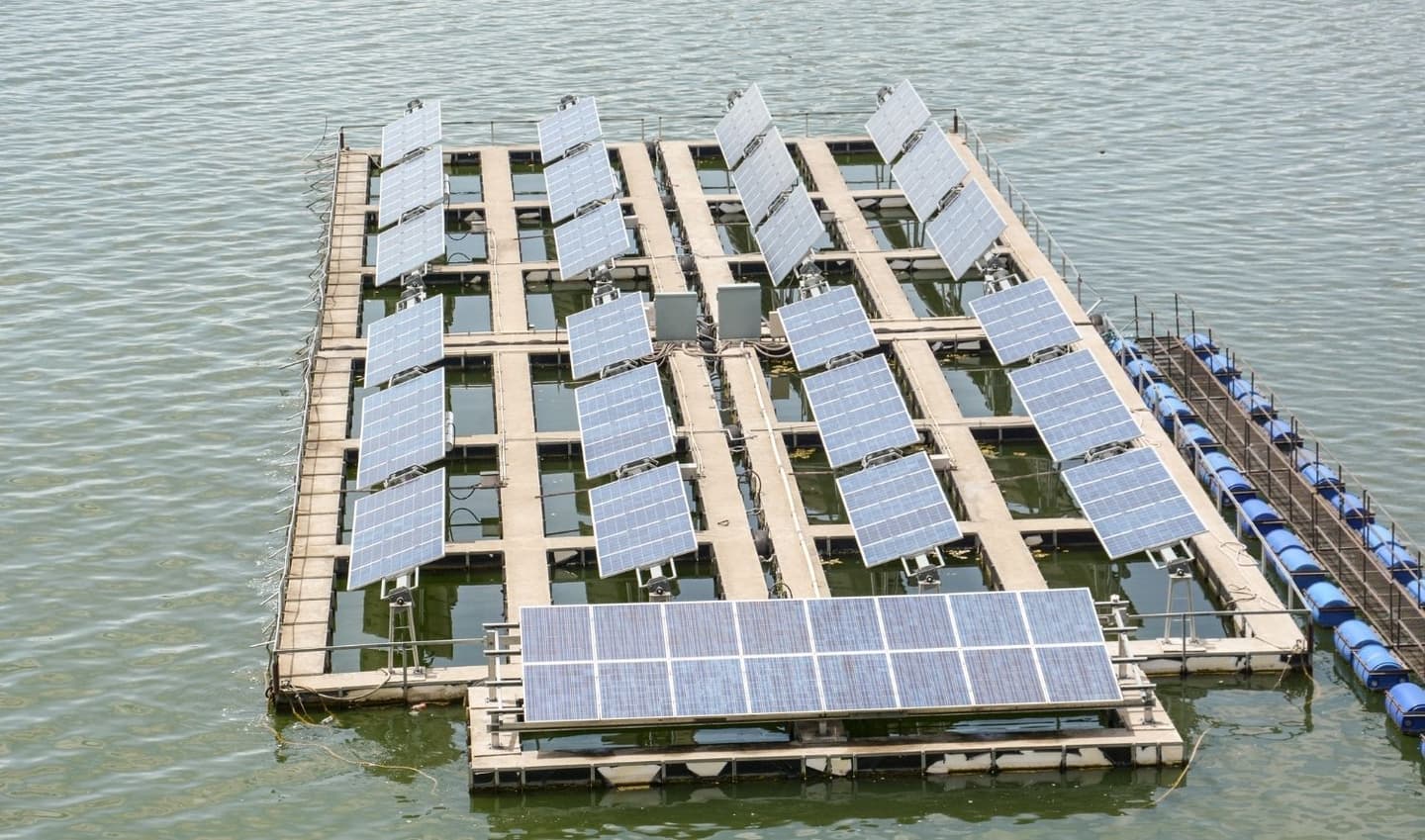 Floating solar panels on a reservoir with battery energy storage.